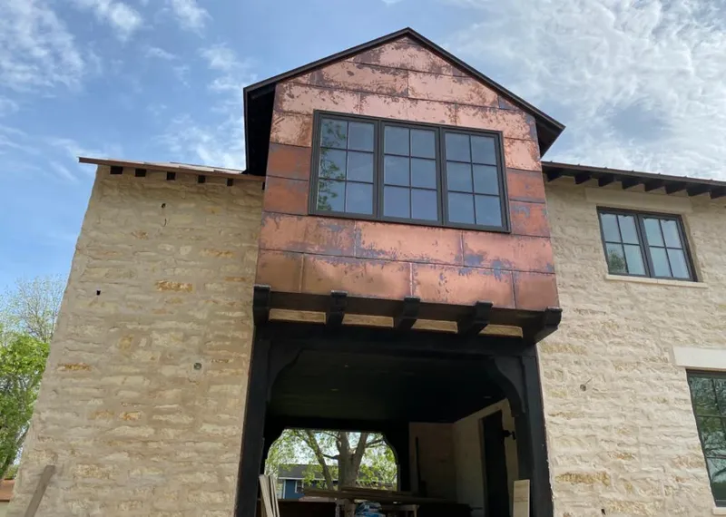 Copper metal panel facade on a stone building for Metal Roof Coating in Adrian